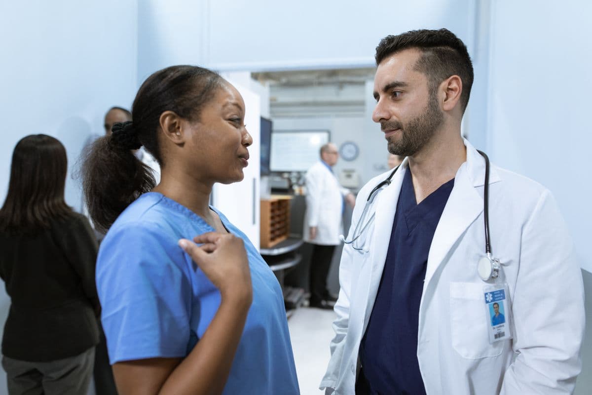 Healthcare team discussing patient care in a hospital hallway