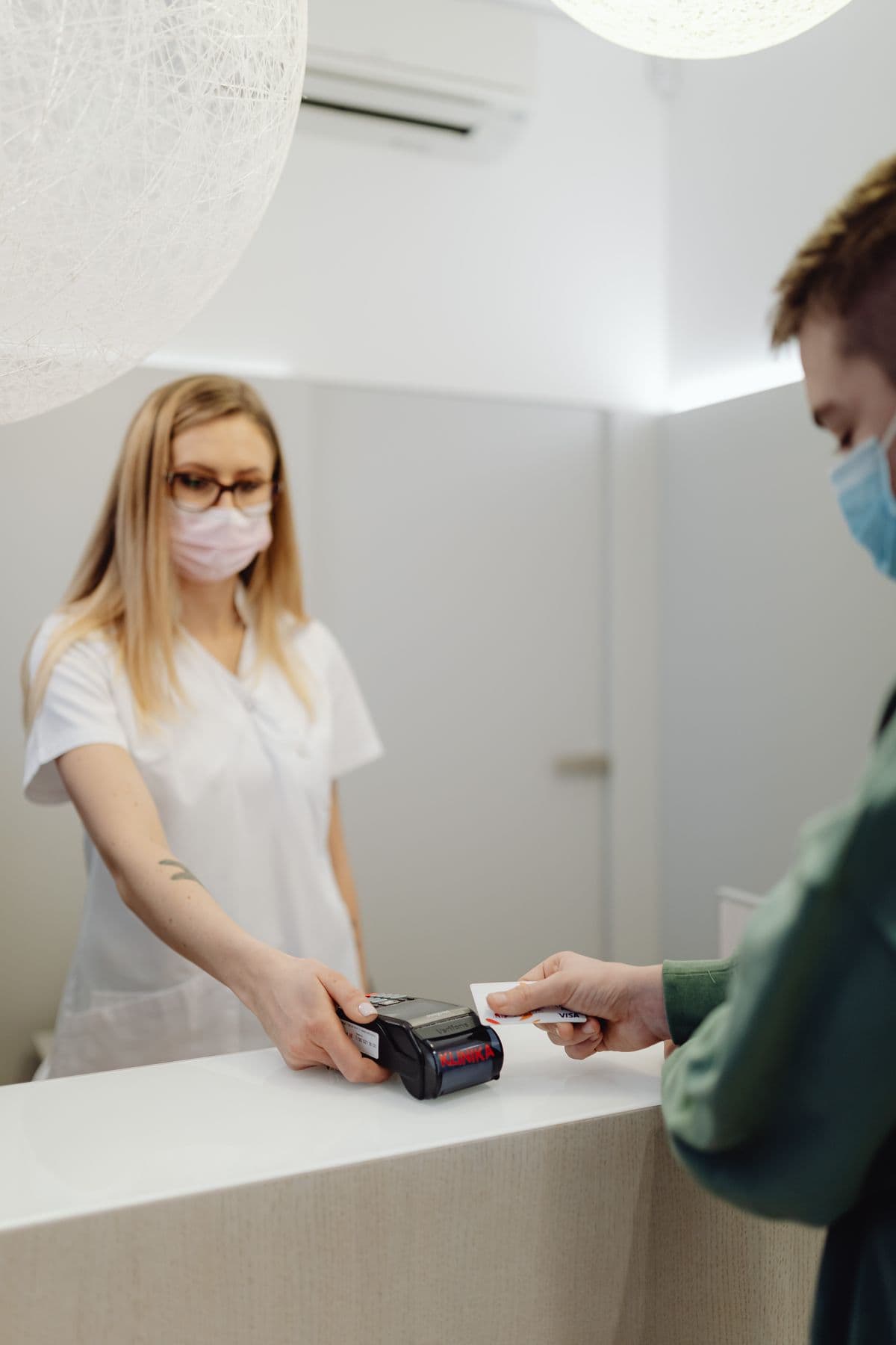 Patient checking in at a clinic front desk